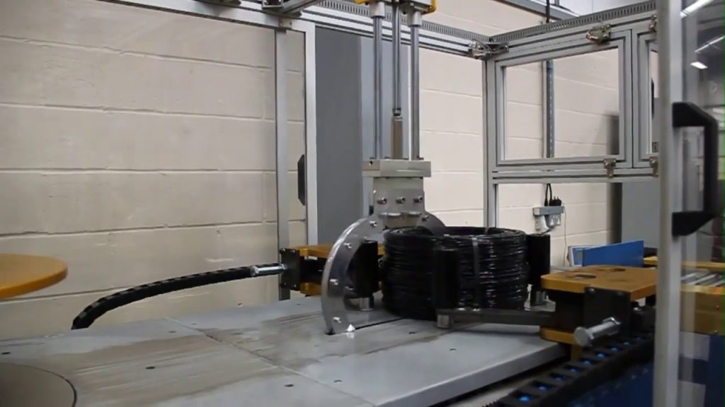 Winding and Strapping of Steel Wire Coils through Automation Winding and Strapping of Steel Wire Coils through Automation