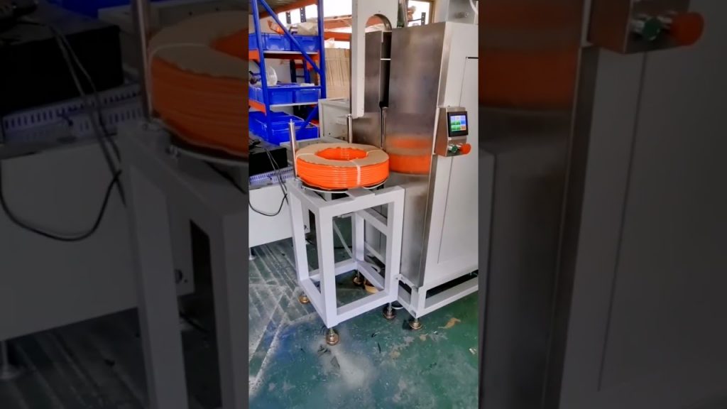 An Automated Strapping Machine for Hose and Pipe Bundles. An Automated Strapping Machine for Hose and Pipe Bundles.