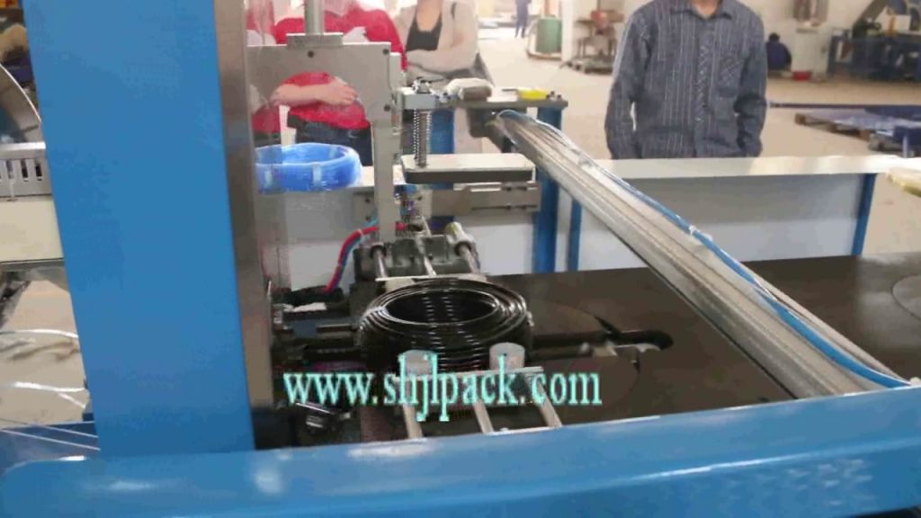 Machinery for coiling and strapping rolls and coils Machinery for coiling and strapping rolls and coils